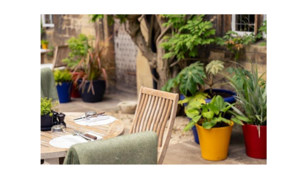Table setting at Parsonage Grill with plants in the background